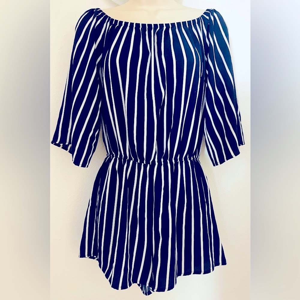 This Navy Short (s) Romper with white pinstripe in a small…no tags but like new.